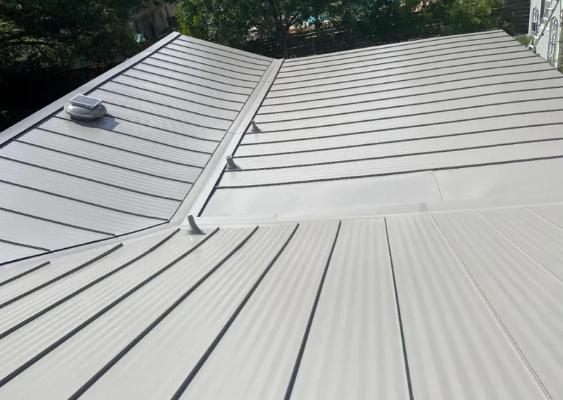 Solar attic fan installed on a metal roof for Roof Ventilation in Two Rivers